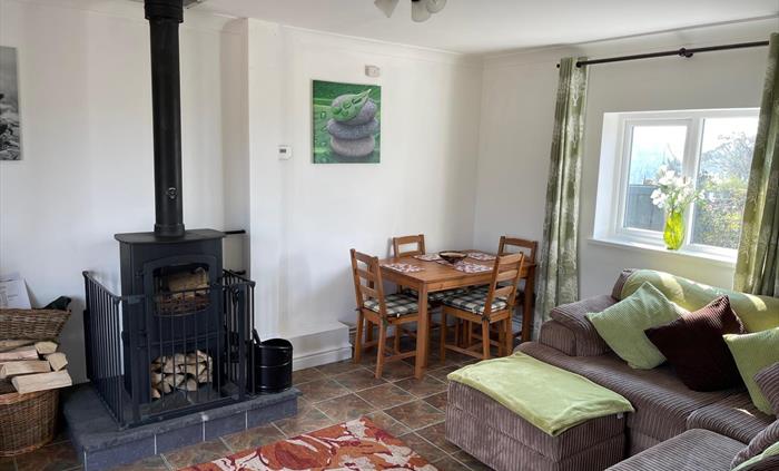 shows the corner sofa, rear window, table and 4 chairs and the Charnwood Cove multi-fuel fire